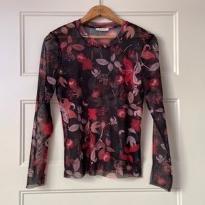 Ladies sheer top with raw sleeves and hemline.